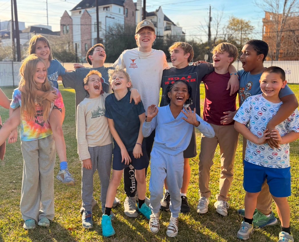 Group of children smiling and laughing together outdoors