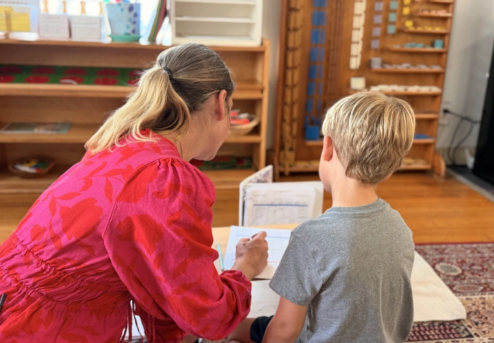 Teacher working one-on-one with a student in a classroom
