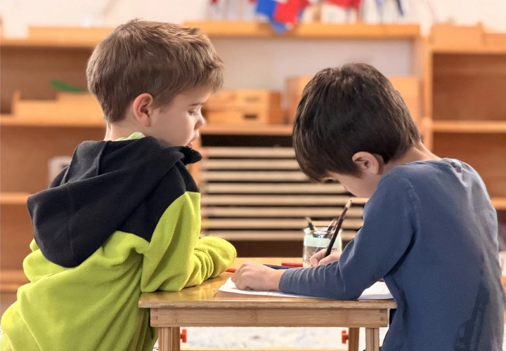 Two children working together at a classroom table
